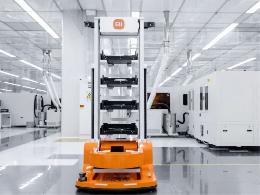 Xiaomi-branded industrial robot working on a smartphone assembly line